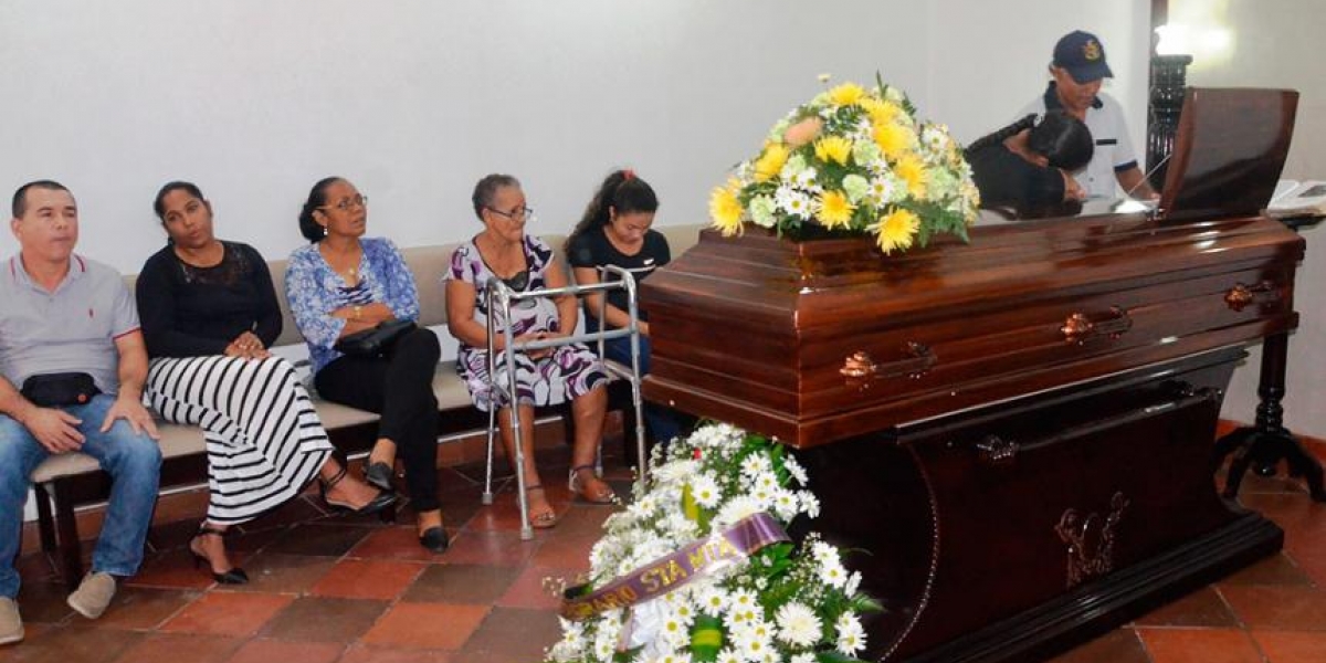 El Heraldo Féretro donde se encontraba el cuerpo de Rafael Viloria. Su hermano Zacarías llora mientras lo observa.
