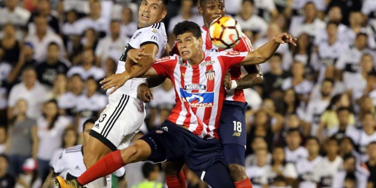 Jorge Arias y Yony González disputan el balón con Juan Patiño.