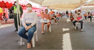 Personas en Makro esperando para redimir el bono solidario.