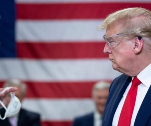 Donald Trump recibiendo una mascarilla.